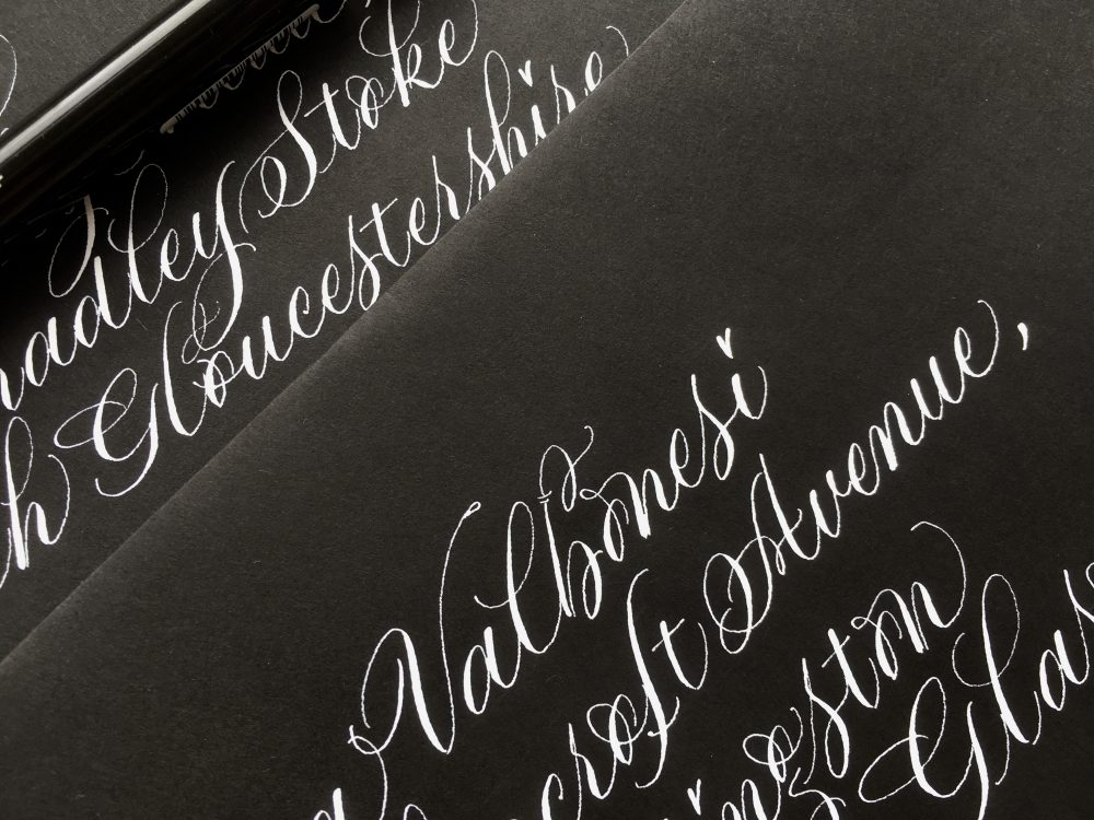 white-copperplate-lettering-on-black-envelopes-for-halloween-uk